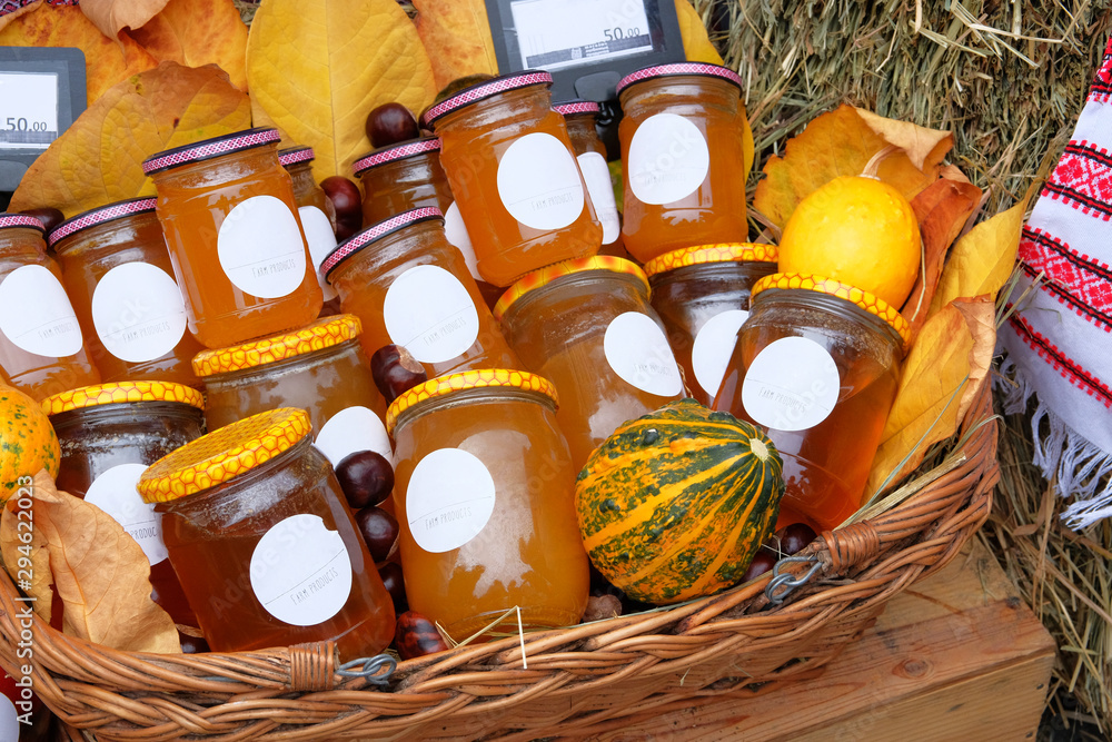 Wall mural jars with different types of honey in farmer agricultural market. farm product in local market. heal