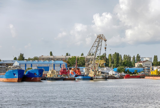 ships for grain transportation and port cranes for loading.River port terminal. Transportation of agricultural products. Soft focus- Image