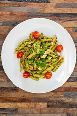 Pasta with pesto sauce and nuts on a the table