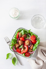keto paleo lunch box with meatballs, lettuce, tomato, cucumber, bell pepper