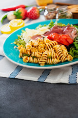 tasty pasta with roast ham on the table