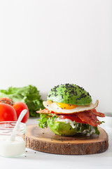 keto paleo diet avocado breakfast burger with bacon, egg, tomato