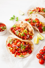 mexican beef and pork tacos with salsa, guacamole and vegetables
