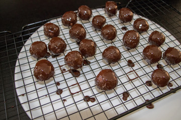 a few chocolate balls above plate close up