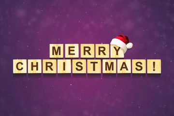 Merry Christmas lettering on wooden blocks on a dark background. Christmas card. F