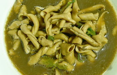  stewed duck intestine in brown soy soup on bowl