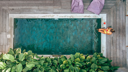 Girl relaxing in pool on Bali villa