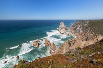Scenic view of the Atlantic Ocean and rugged coast with huge boulders near Cabo da Roca, the...