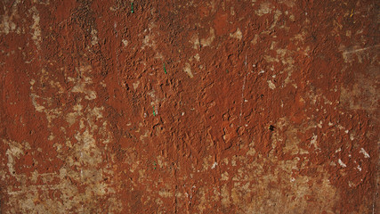  surface of the red stucco peeling wall