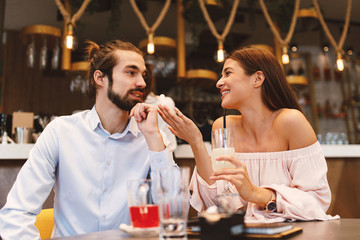 Young happy couple at date in a cafe