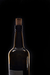 Closeup of an opening of a wine bottle with cork in front of black background with text field