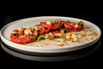 delicious sliced tomato decorated with assorted herbs