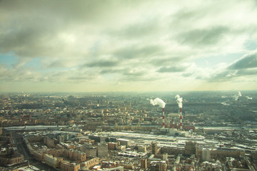 Top view of big city in the winter. Urban panorama of cityscape and blue sky, groups of buildings.