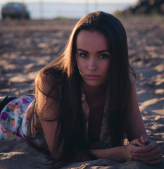 Fototapeta premium fashion outdoor photo of beautiful sexy woman with dark hair in light shirt relaxing at the beach.