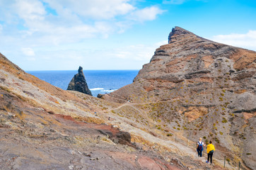 People walking on a hiking trail in Ponta de Sao Lourenco, Madeira, Portugal. Peninsula, easternmost point of the Portuguese island. Volcanic landscape. Hilly terrain. Hikers on a path