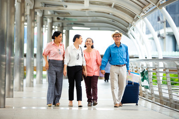 Travel and tourism concept.Group of senior people traveling in the city and looking the map in hand for Shopping Mall Search