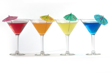 martini glasses with colorful cocktails isolated on white