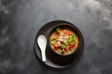 Thai style coconut milk soup-Tom Kha Gai with chicken,mushrooms, galangal, lime leaves, lemongrass, chili peppers. Thai cuisine food concept