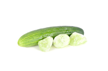 whole and portion cut fresh cucumber on white background