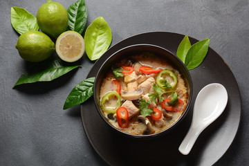 Thai style coconut milk soup-Tom Kha Gai with chicken,mushrooms, galangal, lime leaves, lemongrass, chili peppers. Thai cuisine food concept