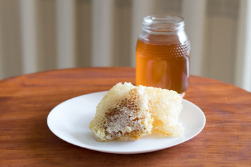 Fresh honey jar and honeycomb, delicious biological product.
