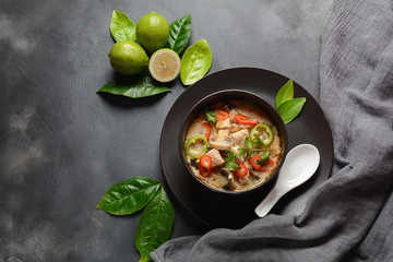 Thai style coconut milk soup-Tom Kha Gai with chicken,mushrooms, galangal, lime leaves, lemongrass, chili peppers. Thai cuisine food concept