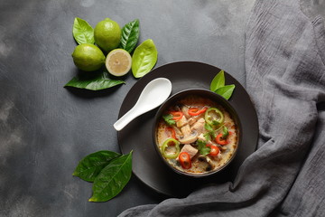 Thai style coconut milk soup-Tom Kha Gai with chicken,mushrooms, galangal, lime leaves, lemongrass, chili peppers. Thai cuisine food concept