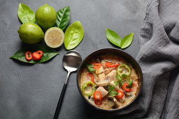 Thai style coconut milk soup-Tom Kha Gai with chicken,mushrooms, galangal, lime leaves, lemongrass, chili peppers. Thai cuisine food concept