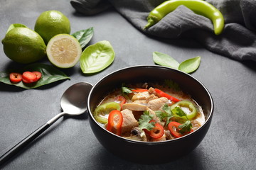 Thai style coconut milk soup-Tom Kha Gai with chicken,mushrooms, galangal, lime leaves, lemongrass, chili peppers. Thai cuisine food concept