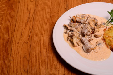 potato pie served with pork stew with mushrooms