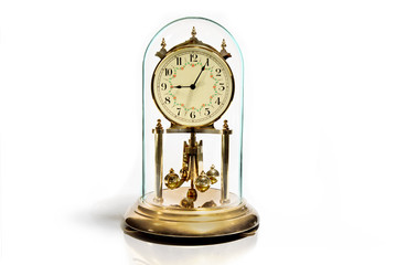 a glass domed perpetual motion anniversary clock