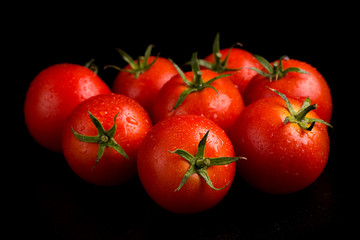 Ripe fresh tomatoes close-up. Red tomatoes on a black background.