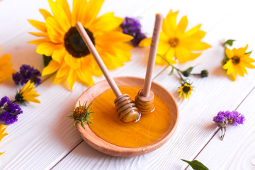 Natural honey with herbs on white wooden background. Organic food, healthy food, sugar dessert