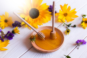 Natural honey with herbs on white wooden background. Organic food, healthy food, sugar dessert