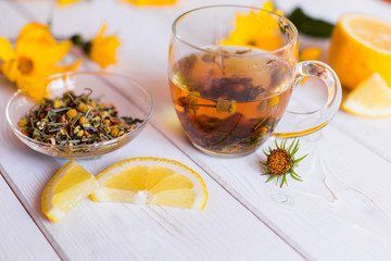 Herbal natural hot tea with different herbs,lemon and honey. Vitamins, healthy lifestyle concept