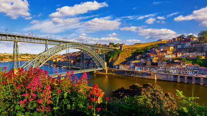 Porto, Portugal. Evening sunset picturesque view at old town with antique houses and red roofs near...