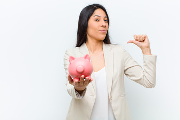 young hispanic pretty woman with a piggy bank