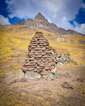 A dirt mound used for drying llama and alpaca waste for use as fuel and fertilizer in the high Andes. Ausungate, Cusco, Peru