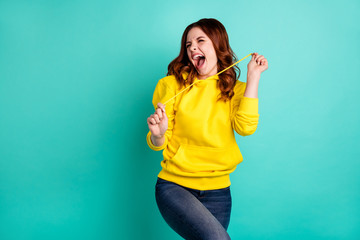 Photo of ecstatic overjoyed lucky fortunate girlfriend screaming with having known new information grimacing isolated over turquoise vivid color background