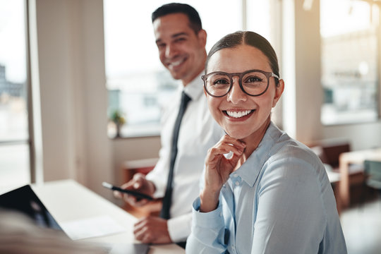 Businesswoman smiling while working with a colleague in an offic
