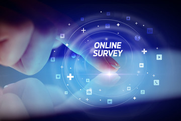 Finger touching tablet with social media icons and ONLINE SURVEY