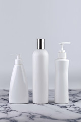 Set of cosmetic bottles, collection empty white bottles of cream with dispenser, shampoo or lotion on white background