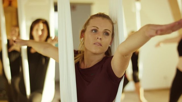 a young blond woman is taking a yoga class in a beautiful bright room - eine junge blonde Frau partizipiert an einem Yogakurs in einem sch&ouml;nen, hellen Raum