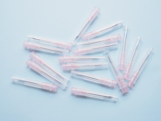 injection needle hypodermic syringe medical equipment for treatment isolated on blue background.