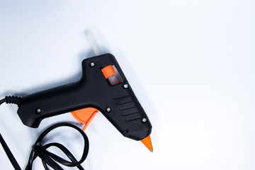 Black glue gun on the white background