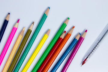The red pen is placed away from many wood colors that have been used. on the white background