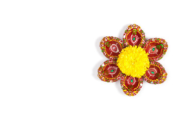 Happy Diwali - Clay Diya lamps lit during Dipavali, Hindu festival of lights celebration. Colorful traditional oil lamp diya on white background. Copy space for text.