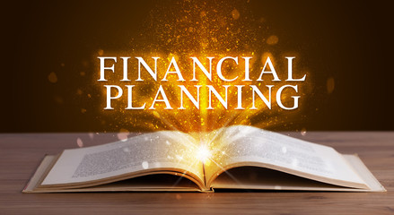 FINANCIAL PLANNING inscription coming out from an open book, educational concept