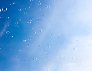 Soap bubbles fly in the blue sky