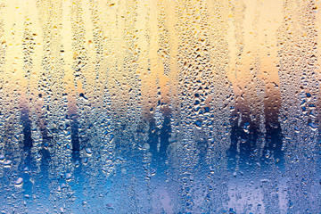 A foggy window at sunset as an abstract background